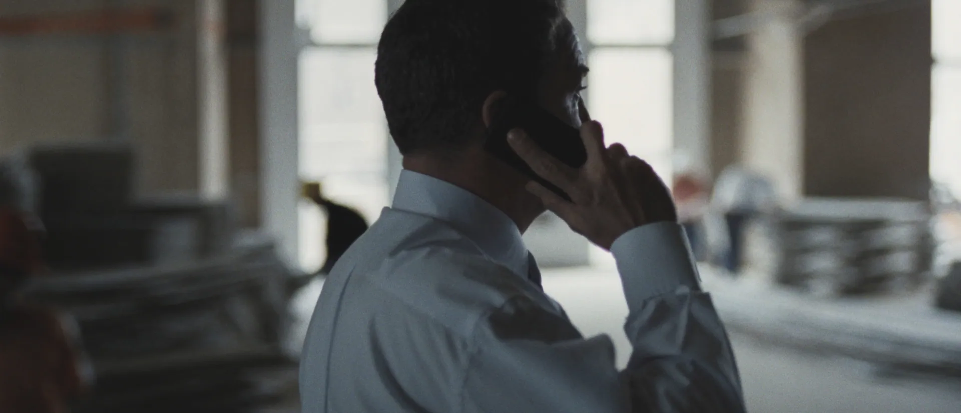 Project manager on the phone walking a fit-out floor